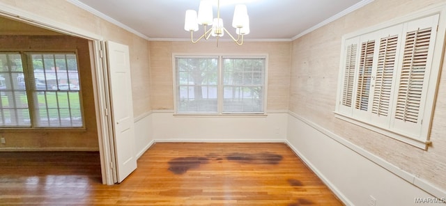 2728 Oxford Dr, Montgomery, AL 36111 - unfurnished dining area featuring a chandelier, wood finished floors, healthy amount of natural light, and crown molding