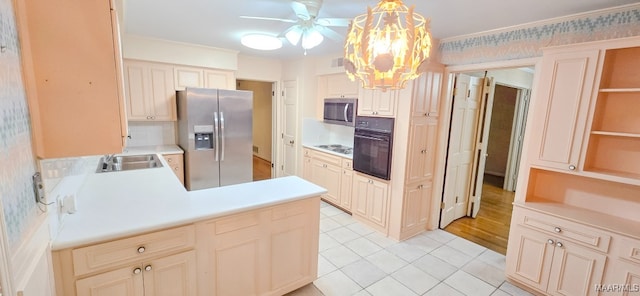 2728 Oxford Dr, Montgomery, AL 36111 - kitchen with appliances with stainless steel finishes, cream cabinets, light tile patterned flooring, a peninsula, and light countertops