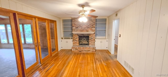 2728 Oxford Dr, Montgomery, AL 36111 - unfurnished living room featuring built in features, wood finished floors, ornamental molding, ceiling fan, and french doors