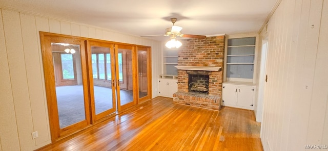 2728 Oxford Dr, Montgomery, AL 36111 - unfurnished living room featuring french doors, light wood-type flooring, built in shelves, crown molding, and a ceiling fan