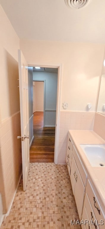 2728 Oxford Dr, Montgomery, AL 36111 - bathroom with tile walls, vanity, wainscoting, and tile patterned floors