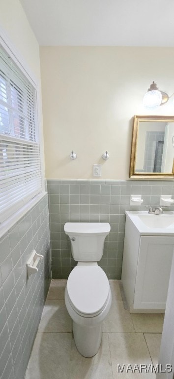 2728 Oxford Dr, Montgomery, AL 36111 - bathroom featuring tile walls, vanity, tile patterned flooring, and wainscoting