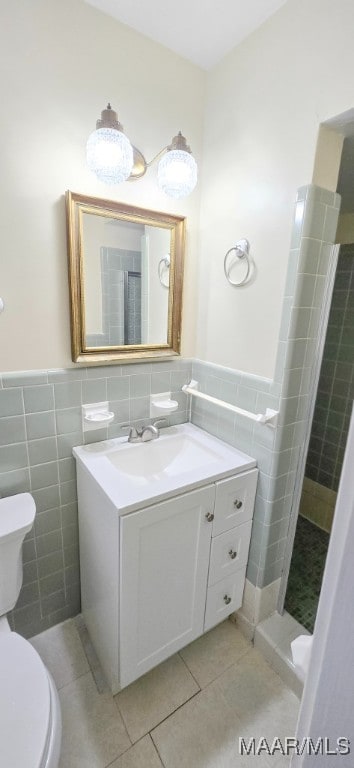 2728 Oxford Dr, Montgomery, AL 36111 - full bathroom featuring tile walls, tile patterned floors, vanity, a shower stall, and wainscoting