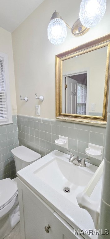2728 Oxford Dr, Montgomery, AL 36111 - bathroom featuring tile walls, vanity, a wainscoted wall, and tile patterned flooring