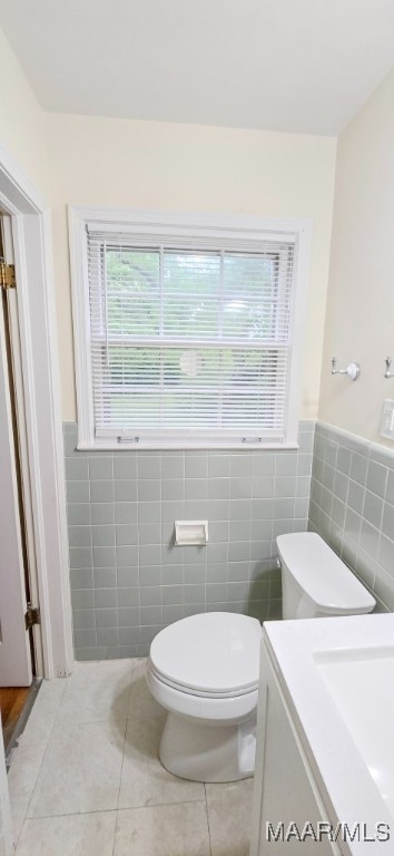 2728 Oxford Dr, Montgomery, AL 36111 - half bath featuring tile walls, tile patterned floors, vanity, and a wainscoted wall