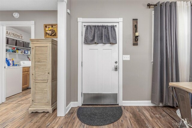 28 Lake Region Dr, Wetumpka, AL 36092 - entrance foyer featuring washer / clothes dryer, light wood finished floors, and baseboards