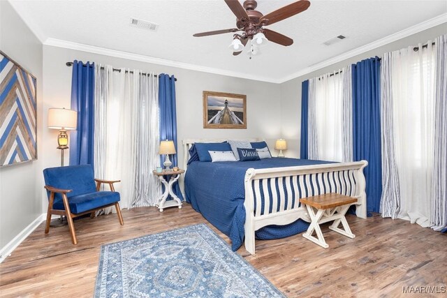 28 Lake Region Dr, Wetumpka, AL 36092 - bedroom with crown molding, wood finished floors, baseboards, and a ceiling fan