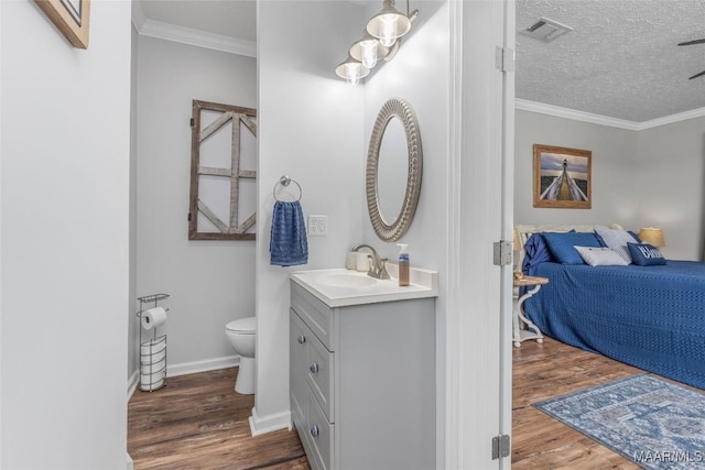 28 Lake Region Dr, Wetumpka, AL 36092 - ensuite bathroom with vanity, wood finished floors, toilet, crown molding, and a textured ceiling