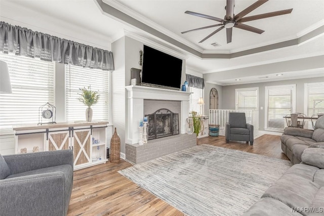 28 Lake Region Dr, Wetumpka, AL 36092 - living area featuring crown molding, a ceiling fan, wood finished floors, a fireplace, and a raised ceiling