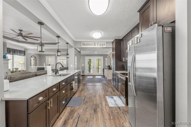 28 Lake Region Dr, Wetumpka, AL 36092 - kitchen with stainless steel appliances, a sink, dark brown cabinets, french doors, and wood finished floors