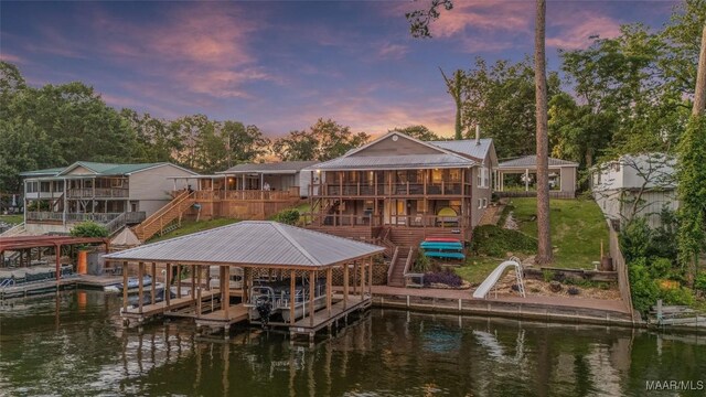 28 Lake Region Dr, Wetumpka, AL 36092 - dock area with stairs, boat lift, a lawn, and a deck with water view