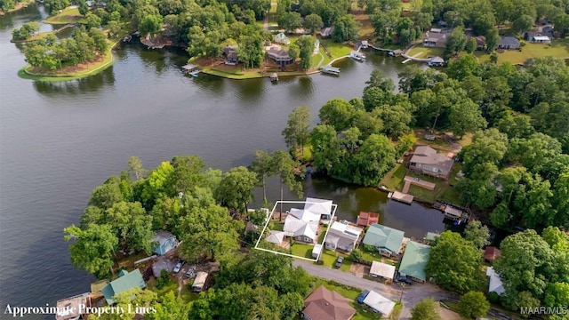 28 Lake Region Dr, Wetumpka, AL 36092 - aerial view of property and surrounding area featuring a nearby body of water, nearby suburban area, property boundaries highlighted, and a tree filled landscape