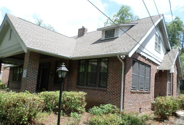 812 E Fairview Ave, Montgomery, AL 36106 - tudor-style house with brick siding, a chimney, and a shingled roof