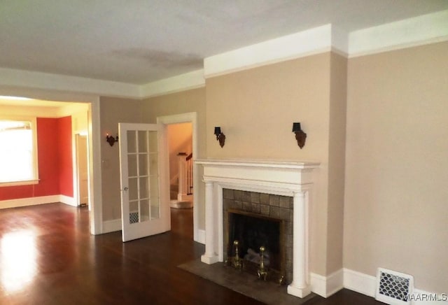 812 E Fairview Ave, Montgomery, AL 36106 - unfurnished living room featuring dark wood finished floors and a tiled fireplace