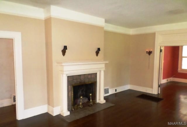 812 E Fairview Ave, Montgomery, AL 36106 - unfurnished living room with dark wood finished floors and a tiled fireplace