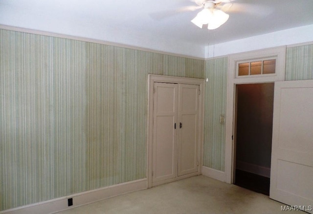 812 E Fairview Ave, Montgomery, AL 36106 - unfurnished bedroom with wallpapered walls, light carpet, a ceiling fan, and a closet
