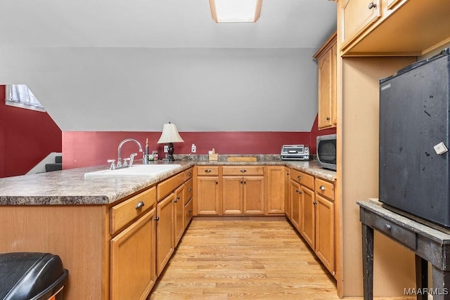 18490 US Highway 31st Rd, Clanton, AL 35045 - kitchen with stainless steel microwave, light wood-style floors, a peninsula, and lofted ceiling