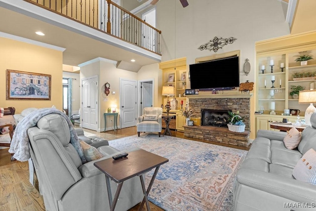 18490 US Highway 31st Rd, Clanton, AL 35045 - living area with a high ceiling, wood finished floors, ceiling fan, a fireplace, and built in shelves