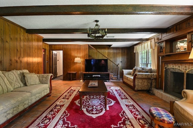 76 Willow Springs Rd, Wetumpka, AL 36093 - living area featuring wood walls, brick floors, beam ceiling, and stairs