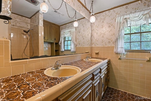 76 Willow Springs Rd, Wetumpka, AL 36093 - full bathroom featuring double vanity, wainscoting, tiled shower, wallpapered walls, and tile walls