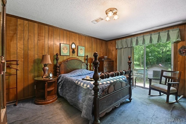 76 Willow Springs Rd, Wetumpka, AL 36093 - carpeted bedroom with a textured ceiling, access to outside, and wooden walls
