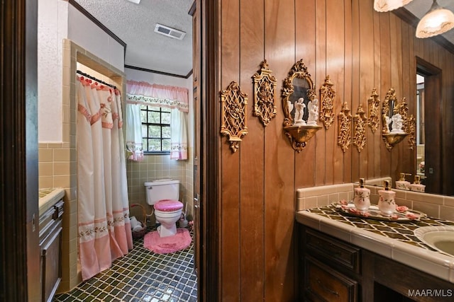 76 Willow Springs Rd, Wetumpka, AL 36093 - bathroom with vanity, a textured ceiling, tile patterned floors, tile walls, and wood walls