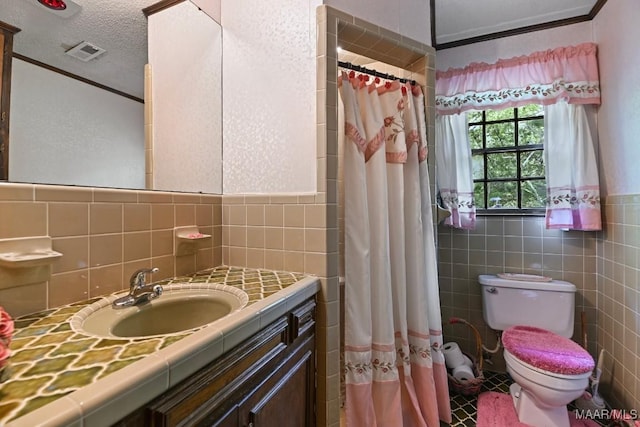 76 Willow Springs Rd, Wetumpka, AL 36093 - full bath with tile walls, vanity, ornamental molding, curtained shower, and a textured ceiling