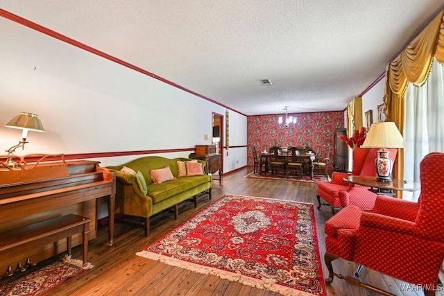 76 Willow Springs Rd, Wetumpka, AL 36093 - living area with wallpapered walls, hardwood / wood-style flooring, ornamental molding, and a textured ceiling