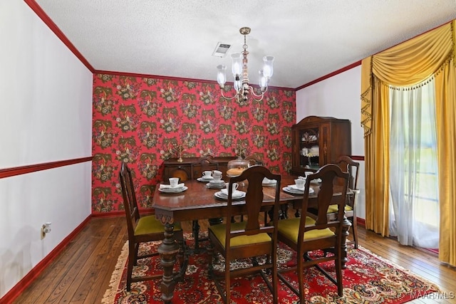 76 Willow Springs Rd, Wetumpka, AL 36093 - dining room featuring ornamental molding, wallpapered walls, wood-type flooring, a chandelier, and a textured ceiling