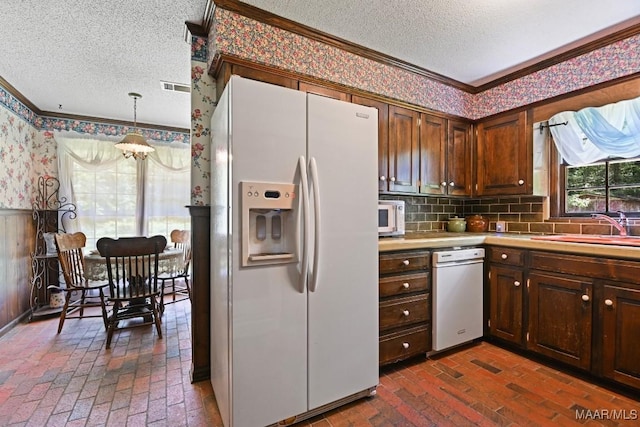 76 Willow Springs Rd, Wetumpka, AL 36093 - kitchen with white appliances, ornamental molding, a textured ceiling, wallpapered walls, and brick flooring