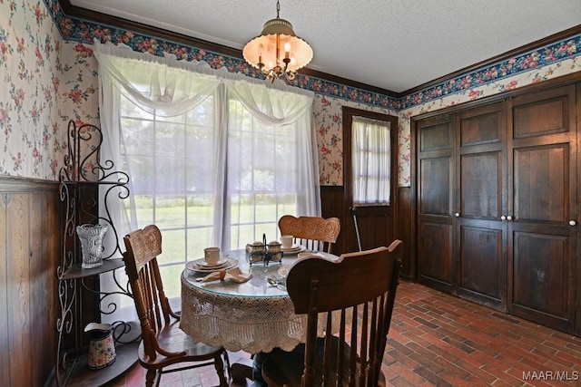 76 Willow Springs Rd, Wetumpka, AL 36093 - dining area with wallpapered walls, a wainscoted wall, brick flooring, a textured ceiling, and ornamental molding