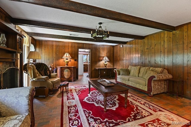 76 Willow Springs Rd, Wetumpka, AL 36093 - living area with brick flooring, a chandelier, wooden walls, beam ceiling, and a fireplace