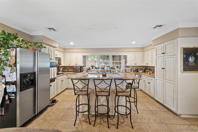 901 Green Forest Dr, Montgomery, AL 36109 - kitchen with appliances with stainless steel finishes, a kitchen breakfast bar, light stone countertops, backsplash, and crown molding