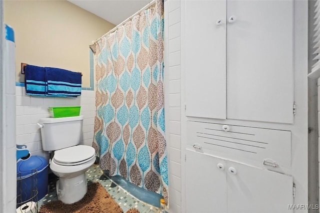 901 Green Forest Dr, Montgomery, AL 36109 - bathroom featuring tile walls, a shower with shower curtain, and wainscoting