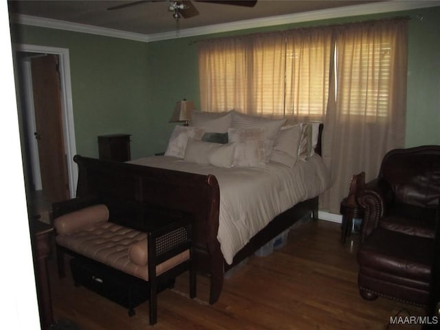 bedroom with wood finished floors, multiple windows, ornamental molding, and a ceiling fan