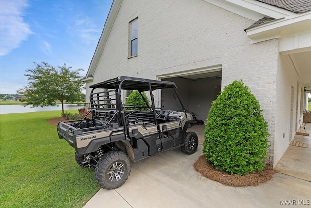 493 Lake Ridge Rd, Hope Hull, AL 36043 - view of side of property with a yard, a water view, brick siding, and a garage