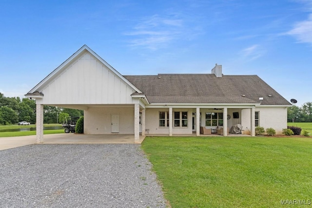 493 Lake Ridge Rd, Hope Hull, AL 36043 - view of front of property with board and batten siding, gravel driveway, a front lawn, brick siding, and a carport