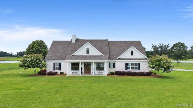 493 Lake Ridge Rd, Hope Hull, AL 36043 - view of front of house with a front lawn, a chimney, french doors, and a water view