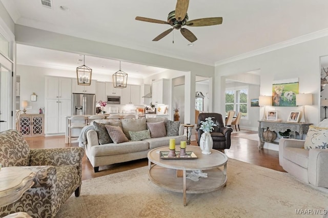 493 Lake Ridge Rd, Hope Hull, AL 36043 - living room featuring light wood-style floors, ornamental molding, and ceiling fan