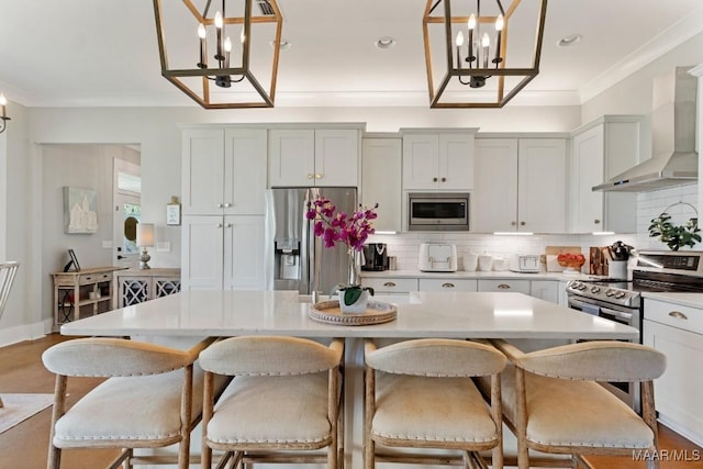 493 Lake Ridge Rd, Hope Hull, AL 36043 - kitchen featuring stainless steel appliances, a chandelier, wall chimney exhaust hood, light countertops, and crown molding