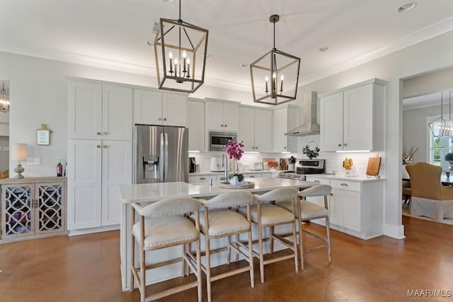 493 Lake Ridge Rd, Hope Hull, AL 36043 - kitchen with stainless steel appliances, wall chimney range hood, a chandelier, finished concrete flooring, and decorative backsplash