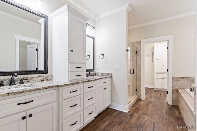 12 Crescent Ridge Ct, Deatsville, AL 36022 - full bath with crown molding, a stall shower, double vanity, wood finished floors, and tiled bath