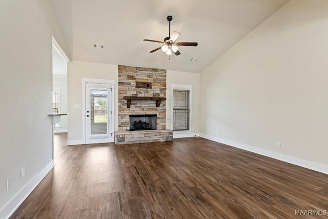 12 Crescent Ridge Ct, Deatsville, AL 36022 - unfurnished living room featuring lofted ceiling, ceiling fan, dark wood-style floors, and a stone fireplace