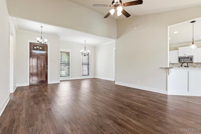 12 Crescent Ridge Ct, Deatsville, AL 36022 - unfurnished living room featuring a chandelier, ceiling fan, dark wood-style floors, crown molding, and vaulted ceiling