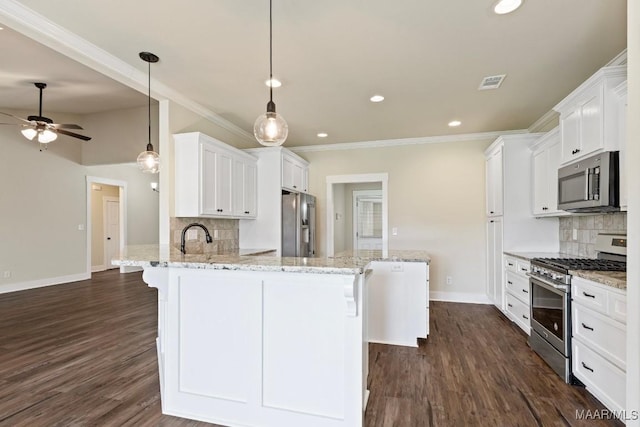 12 Crescent Ridge Ct, Deatsville, AL 36022 - kitchen with appliances with stainless steel finishes, a peninsula, ornamental molding, ceiling fan, and backsplash
