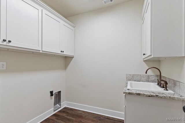 12 Crescent Ridge Ct, Deatsville, AL 36022 - washroom featuring cabinet space and dark wood-style floors