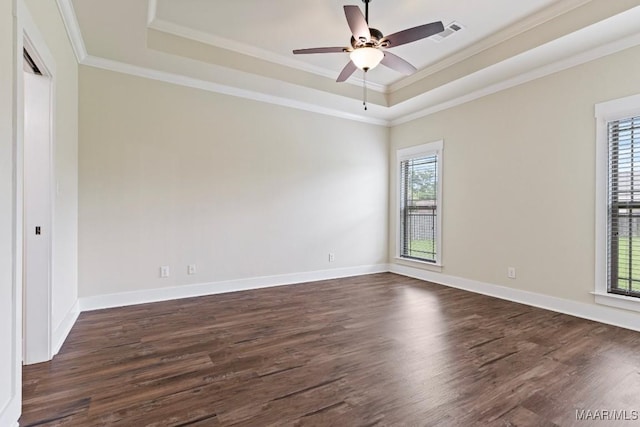 12 Crescent Ridge Ct, Deatsville, AL 36022 - empty room with healthy amount of natural light, a tray ceiling, dark wood-type flooring, and crown molding