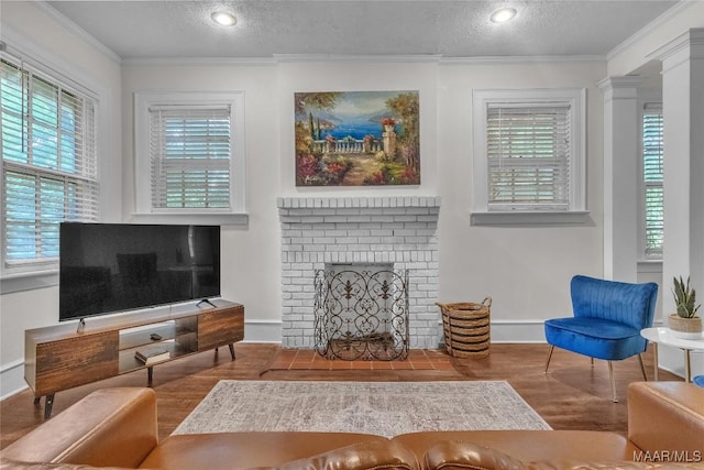 844 E Edgemont Ave, Montgomery, AL 36111 - living area featuring a textured ceiling, healthy amount of natural light, wood finished floors, crown molding, and a fireplace