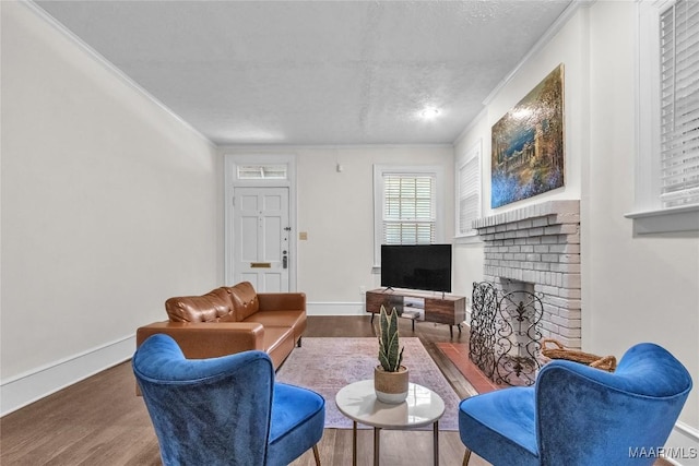 844 E Edgemont Ave, Montgomery, AL 36111 - living area with wood finished floors, ornamental molding, a textured ceiling, and a brick fireplace
