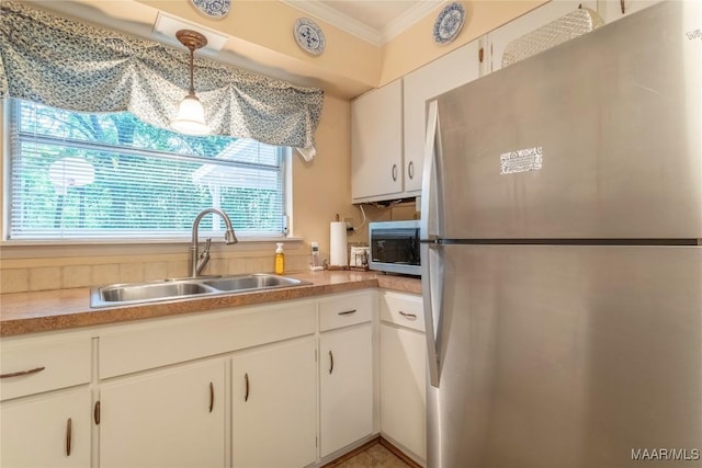 3748 Jasmine Hill Rd, Wetumpka, AL 36093 - kitchen with stainless steel appliances, crown molding, white cabinetry, hanging light fixtures, and light countertops